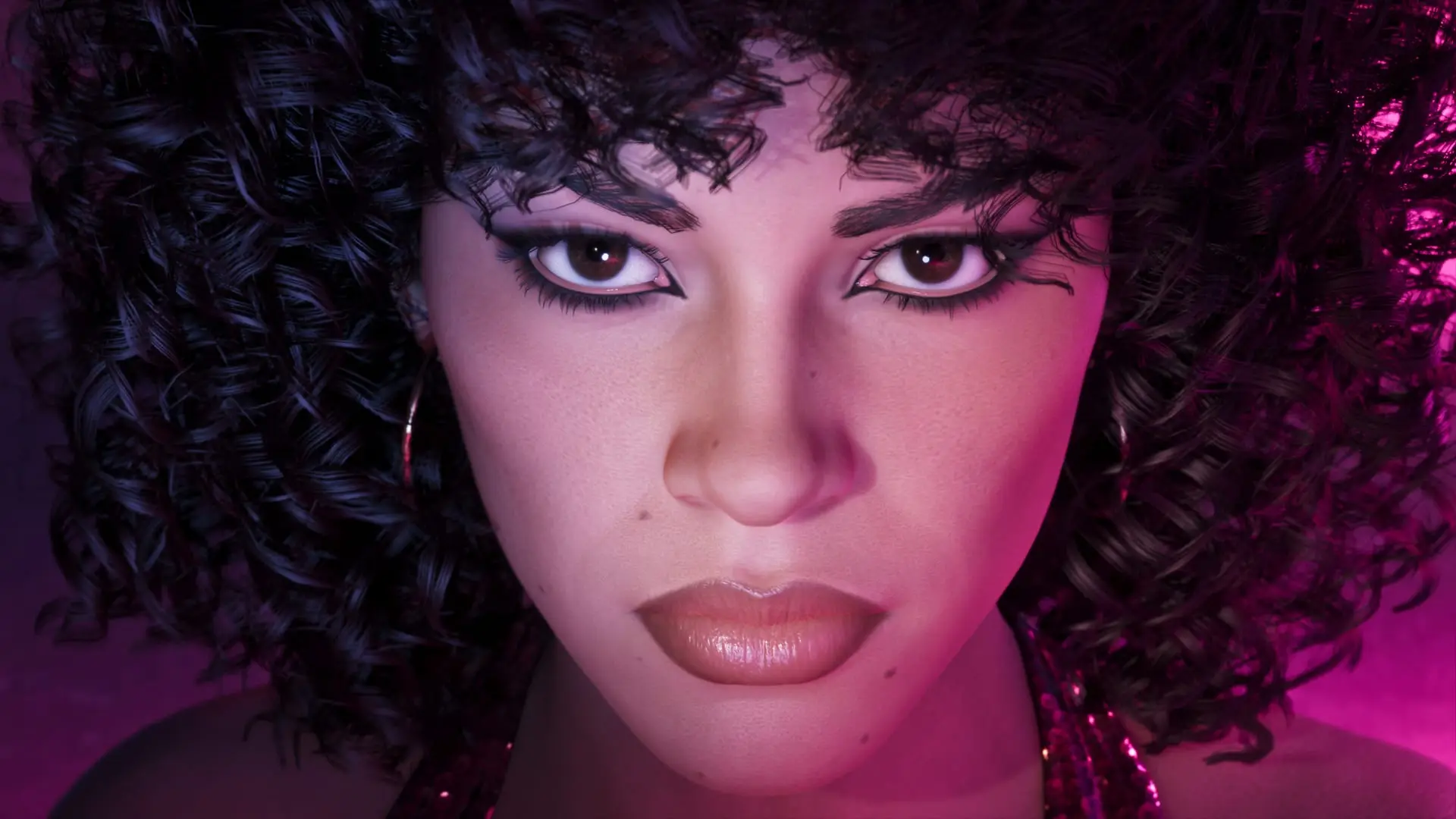 Close-up portrait of a woman with voluminous curly hair and dramatic eyeliner, lit by pink and purple light.