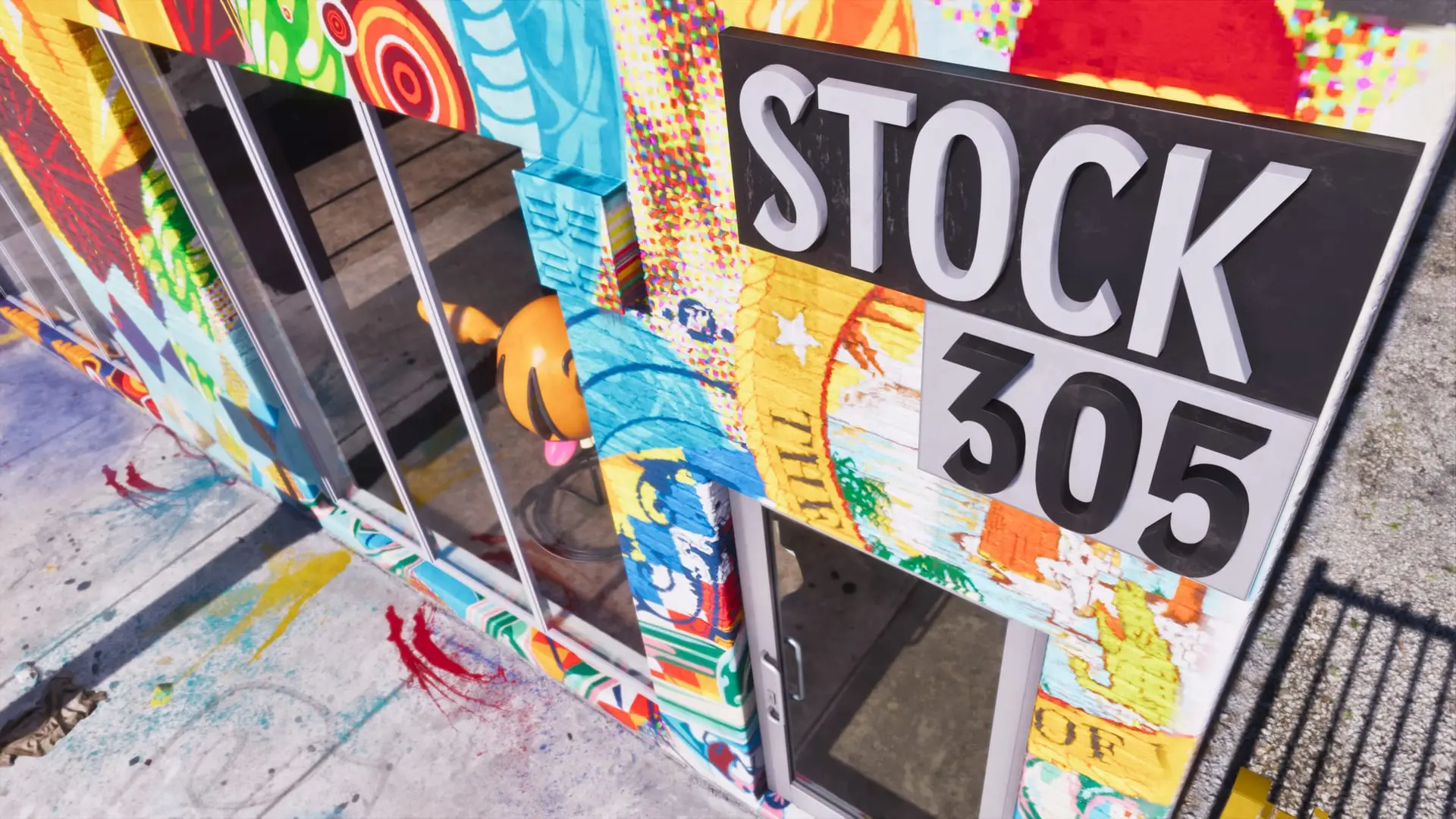 Storefront covered in colorful graffiti murals with a black sign reading Stock 305 beside a glass door.