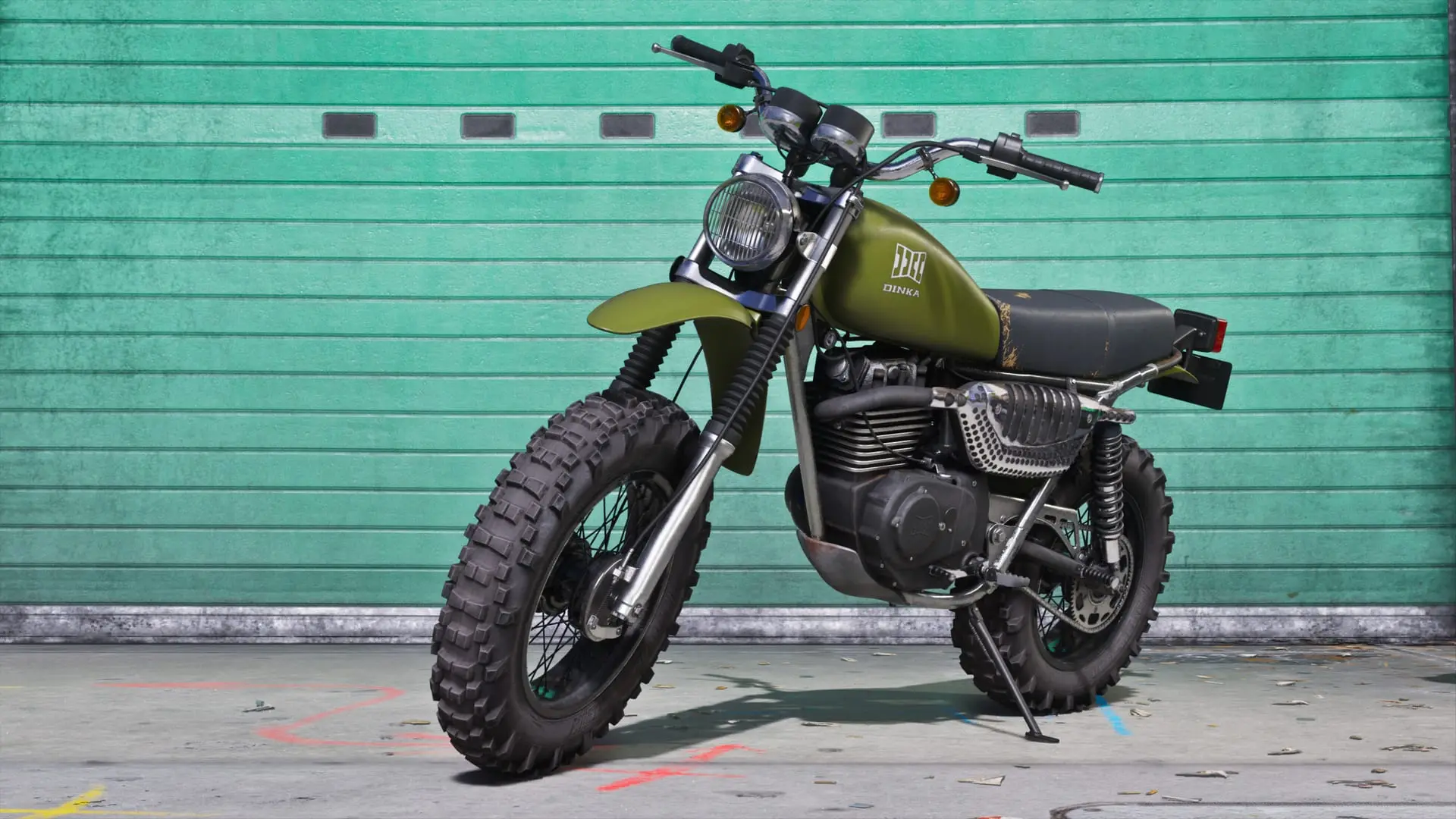 Green custom scrambler motorcycle with knobby tires parked in front of a green garage door.